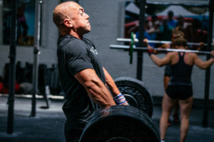 A male weightlifter doing clean pulls.