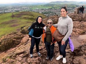 Three Invictus members on the top of a mountain.