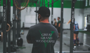 Male wearing an Invictus V shirt with the words "Great, Grand, Wonderful" over the logo.
