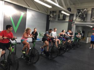 6am group session with class members warming up on the Assault Bikes.