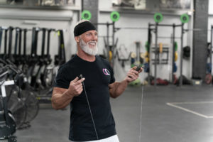 Male masters athlete smiling with his jump rope before crushing a set of double-unders.