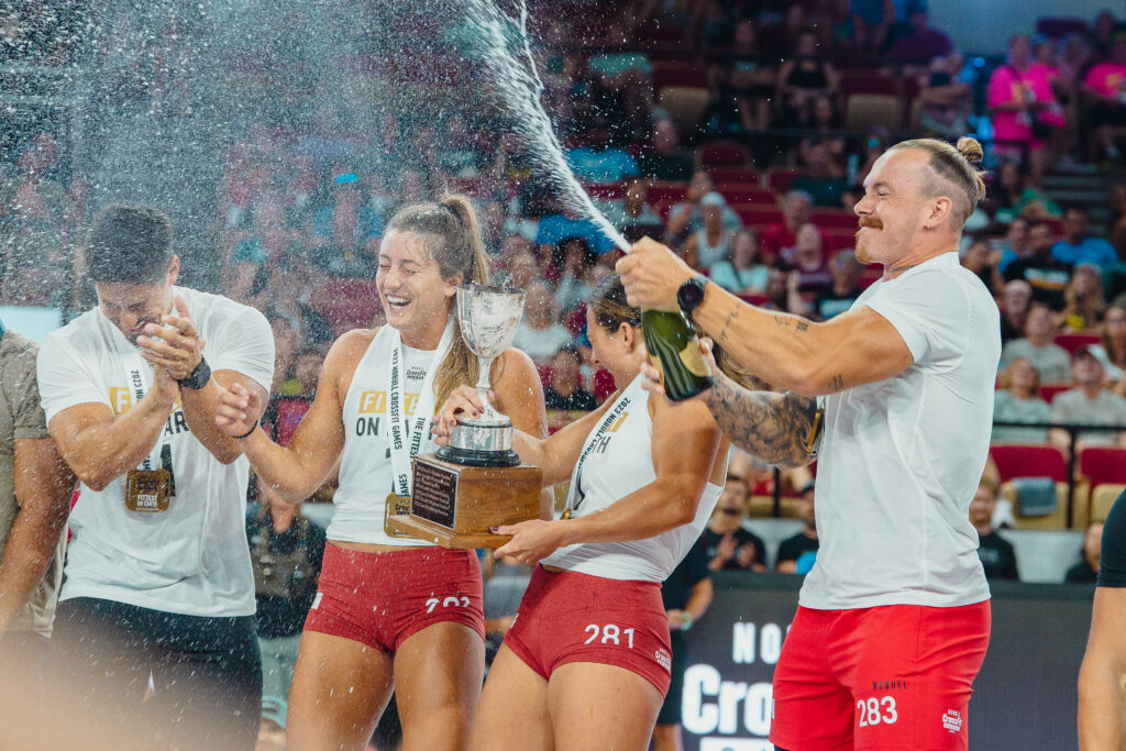 Team Invictus winning the 2023 CrossFit Games Affiliate Cup and popping champagne. 